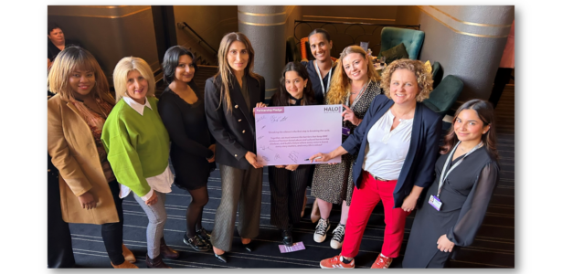 Yasmin Khan Director of The Halo Project and Jo Coles Deputy Mayor for Policing Fire and Crime with members of the Halo team holding the partnership pledge